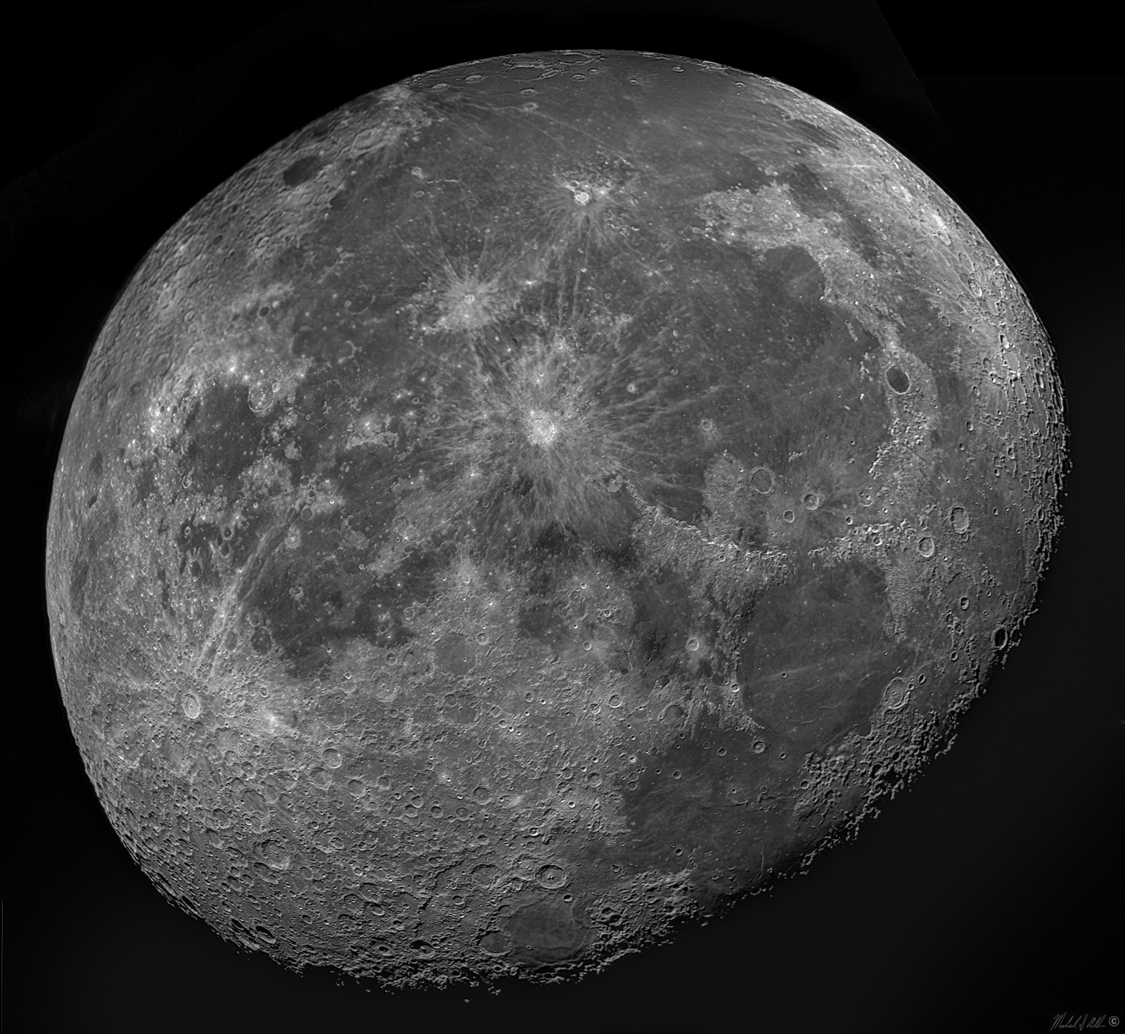 A waning gibbous moon, its right edge still in shadow