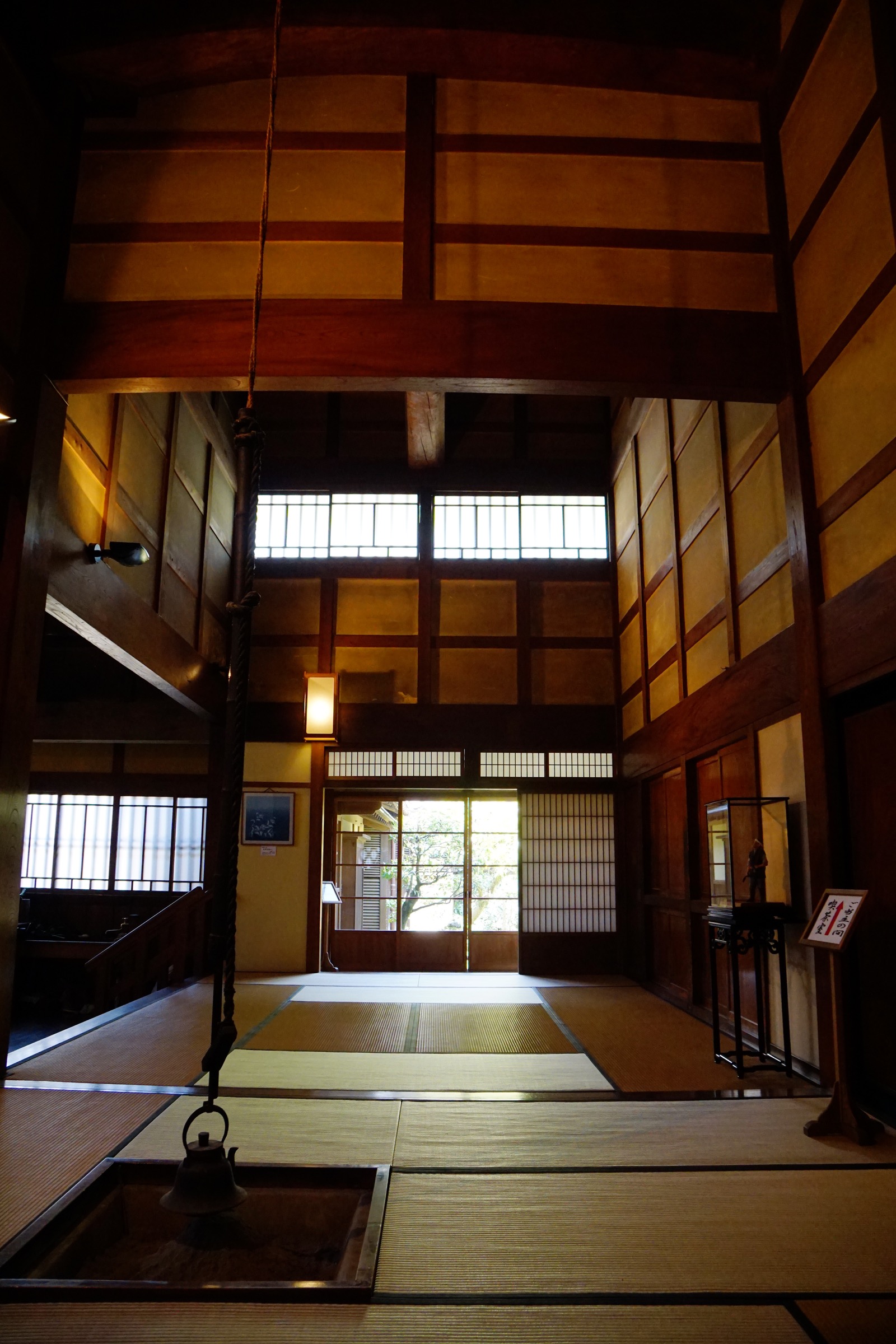 Late-afternoon light filtering through shoji paper screens into a tatami room at the Ishitani Residence, Tottori