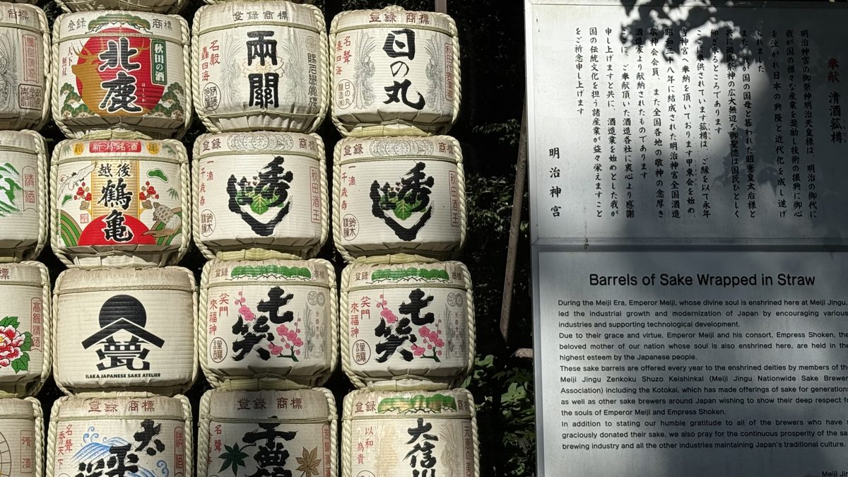 A wall of straw-wrapped sake barrels offered to Meiji Jingu